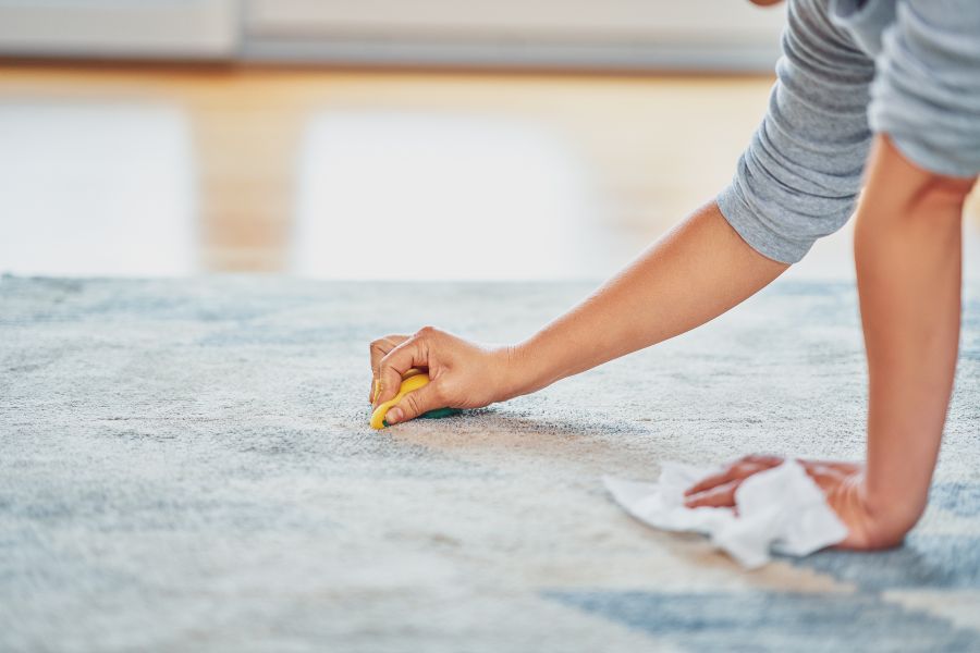 Gum residue on a rug being cleaned with simple household methods.